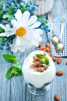 desert with cream and dry almond in glass