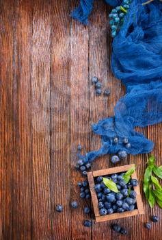 blueberry in wooden box and on a table