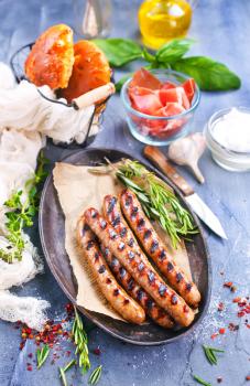 sausages on plate and on a table