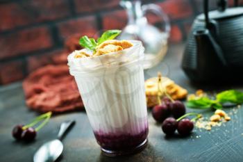 white yogurt with berries and cookies, desert in glass