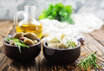 cheese with spice and olives on a table