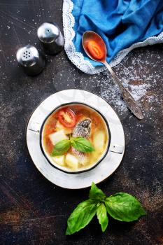 fish soup in bowl and on a table