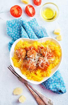 pasta with meat balls and cheese on plate