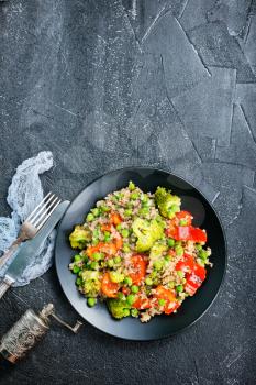 Quinoa salad with pepper, avocado , broccoli and oil . Vegan superfood