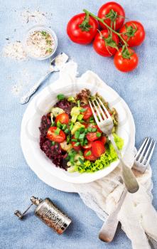 fresh salad on plate, vegetable salad in bowl