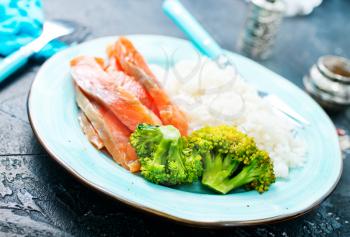 rice brocoli salnob on plate on a table
