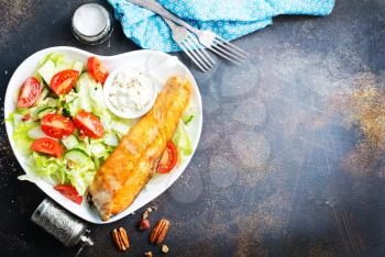 salmon with vegetable salad on white plate