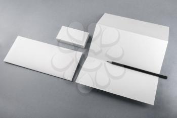 Photo of blank stationery set for branding identity on gray background. Mockup for design presentations and portfolios.