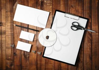 Photo of blank stationery set on vintage wooden table background. Template for branding identity. Mock-up for ID. For design presentations and portfolios. Top view.