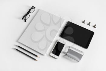 Brand identity template. Photo of blank corporate stationery and gadgets set on white paper background.