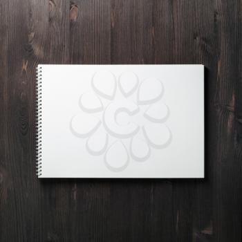 Blank spiral notebook on wood table background. Space for text. Flat lay.