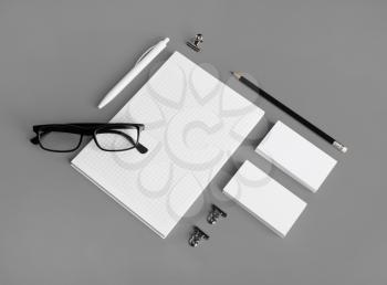 Photo of blank stationery set on gray paper background. Corporate identity mock up for placing your design.