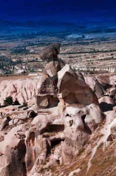 Vertical vibrant Turkey rock sculptures mountain background