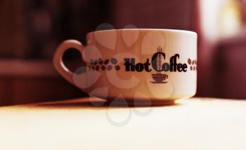 Horizontal hot cup of coffee bokeh background