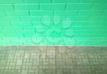 Pale green symmetric street brick wall background