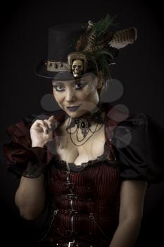 Emotional Portrait of Young Woman in Steampunk or Retro style. Studio shot. Model on a Black Background