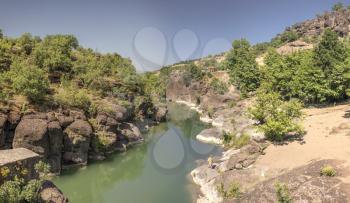 Venetikos river with green water and  beautiful rock formations near Meteora in Greece