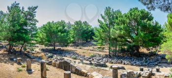 Ruins of the Western Gate street in the ancient city of Priene, Turkey, on a sunny summer day.
