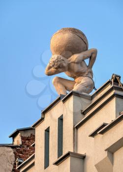 Plovdiv, Bulgaria - 07.24.2019. Statue of Atlas on the roof of the building. Knyaz Alexamder Street in Plovdiv, Bulgaria, on a sunny summer day