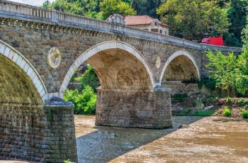 Veliko Tarnovo, Bulgaria - 07.25.2019. Bridge over the Yantra River near Veliko Tarnovo Fortress, Bulgaria, on a sunny summer day