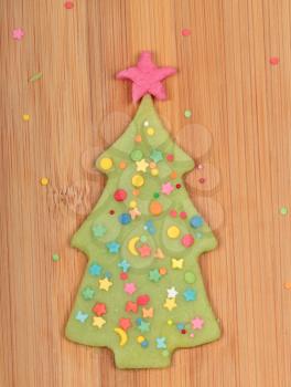 Christmas tree cookie on bamboo kitchen board