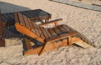 Wooden chaise lounge on the beach. Furniture for a beach holiday.
