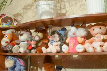Soft toys on the shelf. Children's toys made of soft materials.