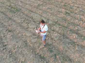 The man is holding a remote control from the quadrocopters. Photographer's work with gadgets.