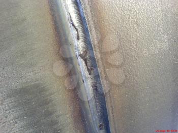 Welded seam on the pipeline. Compound of metal.