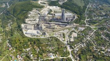 Verkhnebakansky cement plant, top view. Factory for the production and preparation of building cement. Cement industry.