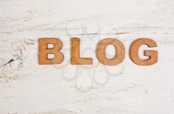 the word blog with wooden letters on a white background old wooden