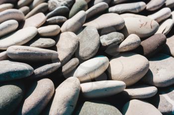 Marine naturally rounded gravel, pebbles in a row. Nature Background Texture