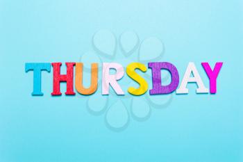 Word Thursday in colorful letters on a blue background