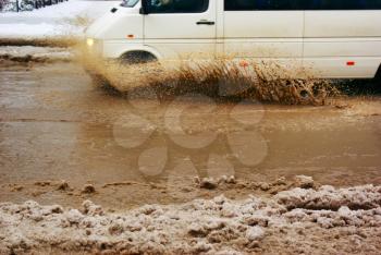 Car splash the puddle. Dynamic scene.