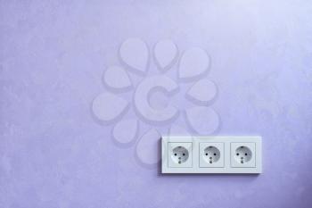 Wall socket and violet wall. After repair scene. 