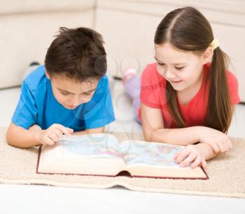 Happy children is reading book