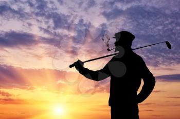 Golf concept. The man with the club playing golf at sunset background