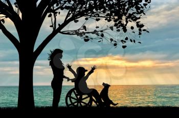 Happy boy in wheelchair and nurse sea under tree and dog sunset. Happy disabled child concept
