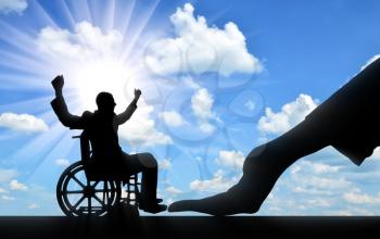 Disabled worker. Silhouette of a big hand of an employer hires a happy disabled man in a wheelchair