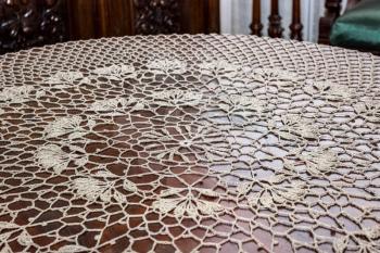 Beautiful vintage crocheted doily is on the table.