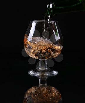 Cognac or brandy on a black background