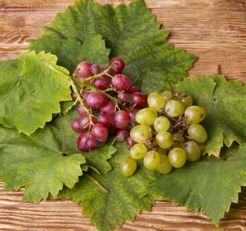 Bunch of grapes on a wooden table.