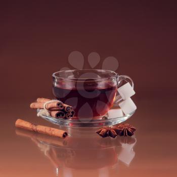 Cup of tea on glass with orange background