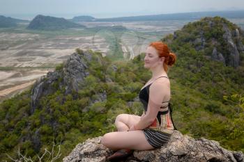 landscape viewpoint at Khao Daeng ,Sam Roi Yod national park,Prachuapkhirikhan province Thailand. girl with red hair enjoys the beauty of nature and meditates