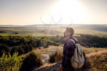 A man standing on a mountain as the sun sets. Goals and achievements concept photo composite. Concept vision, Hiker looking mountain and enjoying sunrise