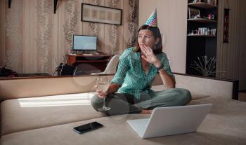 woman celebrating birthday online in quarantine time through video call virtual party. Coronavirus outbreak 2020. sad depressed woman