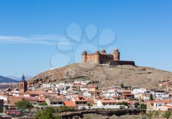Well preserved castle with four round towers above La Calahorra, Andalucia, Spain
