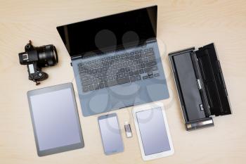 Overhead view of many computing and smartphone screens to illustrate the concept of responsive design or template