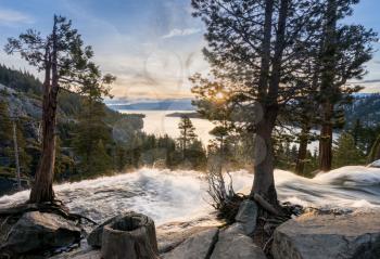 Sunrise at Emerald Bay on Lake Tahoe from the top of Lower Eagle Falls. Torrent of water from snow melt flows into the lake from Sierra Nevada Mountains