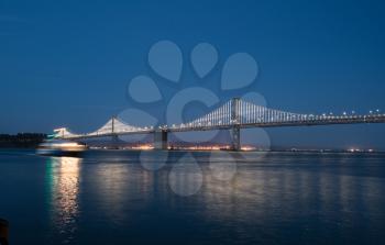 New LED lighting on the Bay Bridge between the downtown San Francisco and Treasure Island across the bay reflects in the water